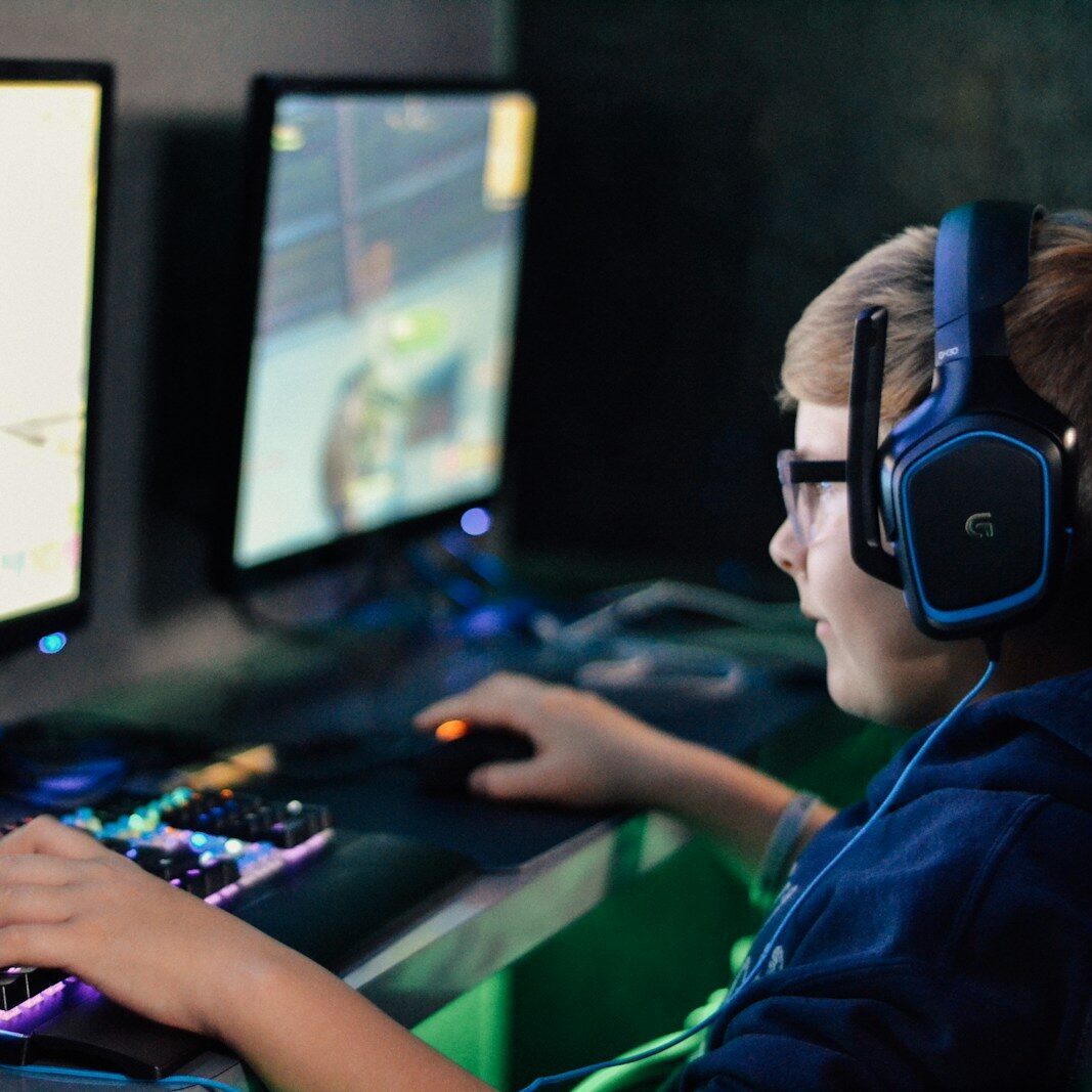 boy wearing headset playing computer game